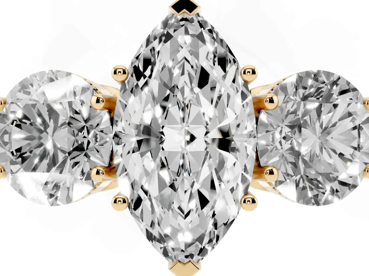 Three-Stone Marquise Cut Diamond Engagement Ring with Prong Setting on a Classic Band Yellow gold