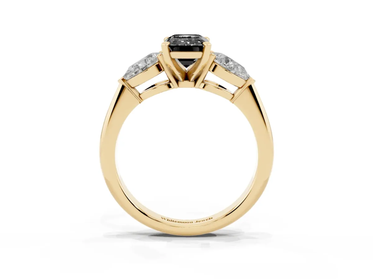 Fancy Black Three-Stone Emerald Cut Diamond Ring with Pear Side Stones and Four-Prong Setting Yellow gold