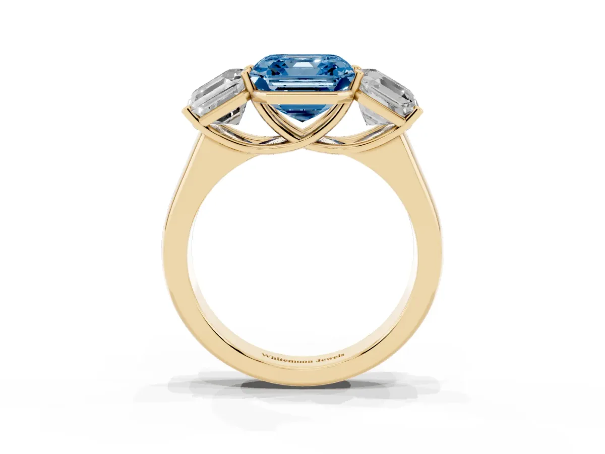 Fancy Blue Asscher Cut Three-Stone Diamond Ring with Prong Setting on a Classic Band Yellow gold