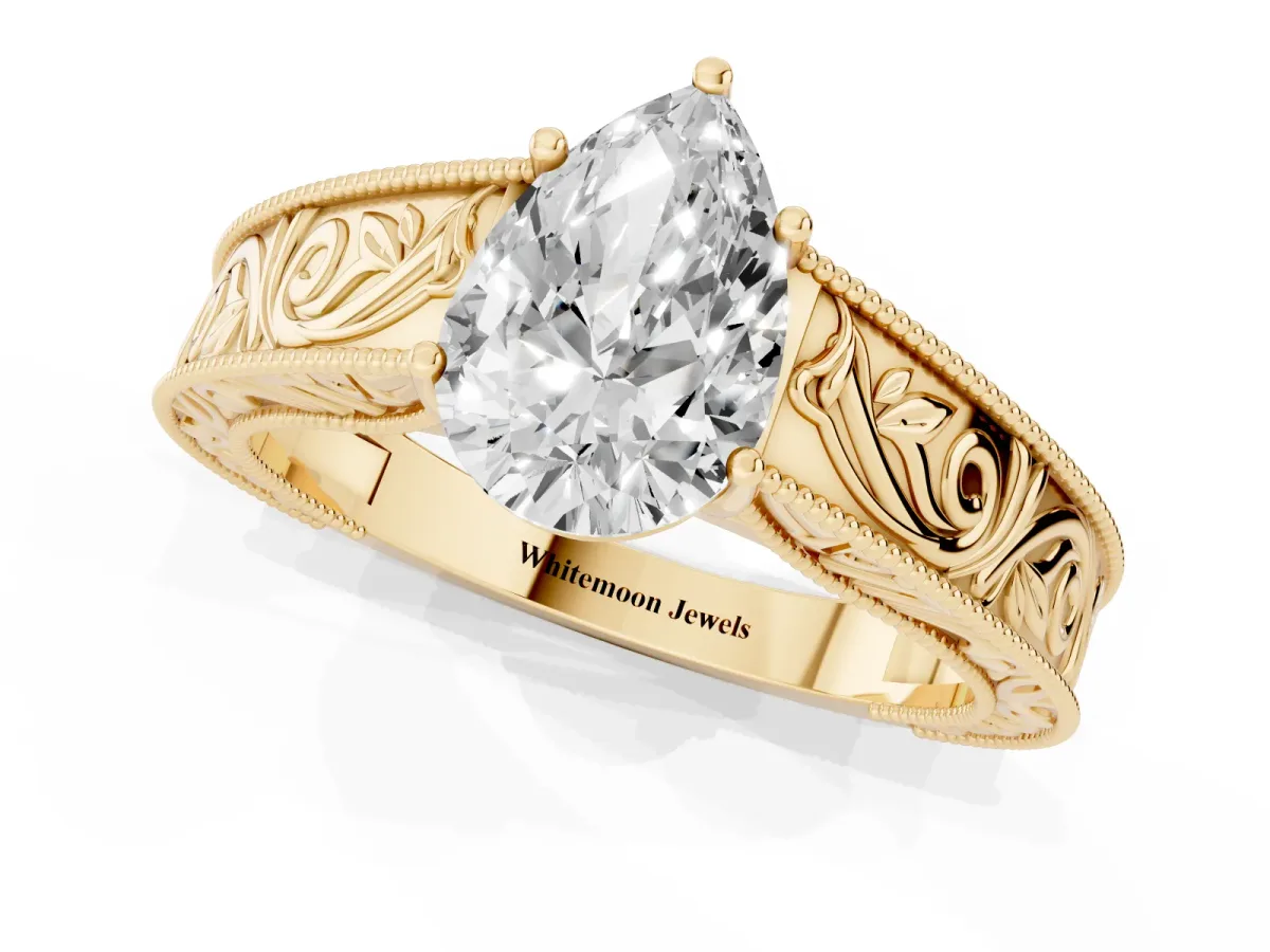 Pear Cut Diamond Solitaire Ring with Engraved Band and Four-Prong Setting Yellow gold