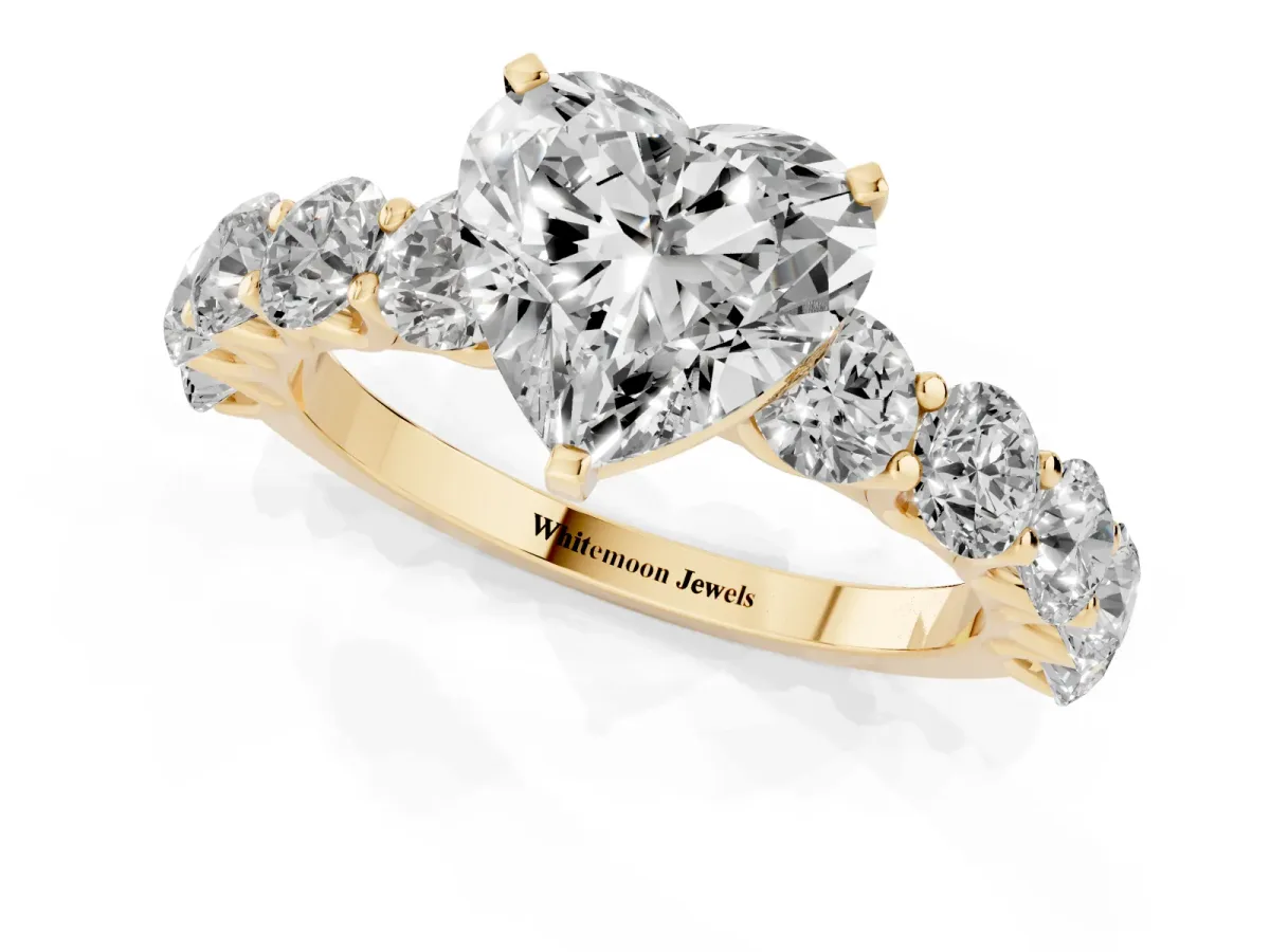 Heart Cut Diamond Prong Setting with Side Stones on a Pave Band Yellow gold