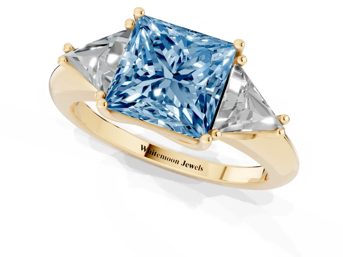Fancy Blue Three-Stone Princess Cut Diamond Engagement Ring with Trillion Side Stones and Prong Setting Yellow gold