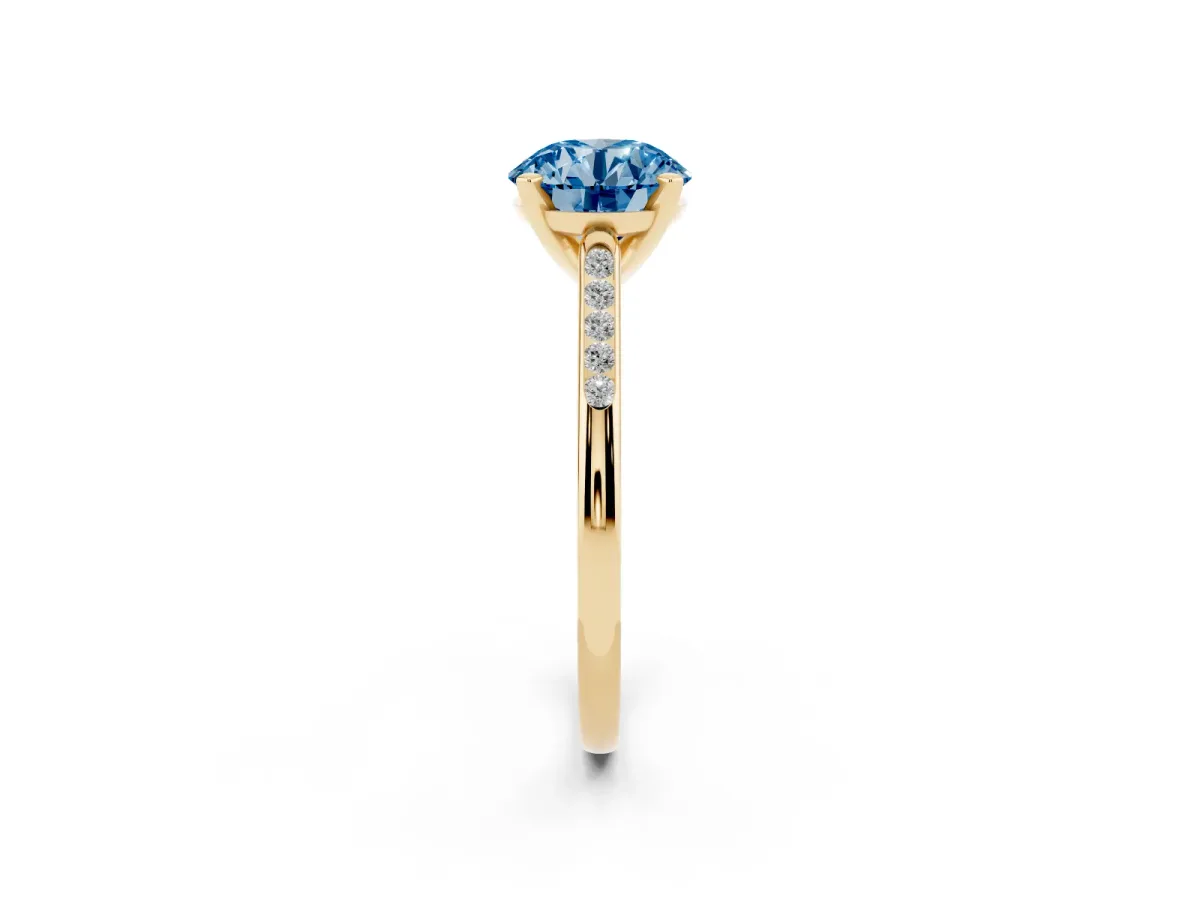 Fancy Blue Round Cut Diamond Solitaire Ring with Channel Set Round Band and Prong Setting Yellow gold