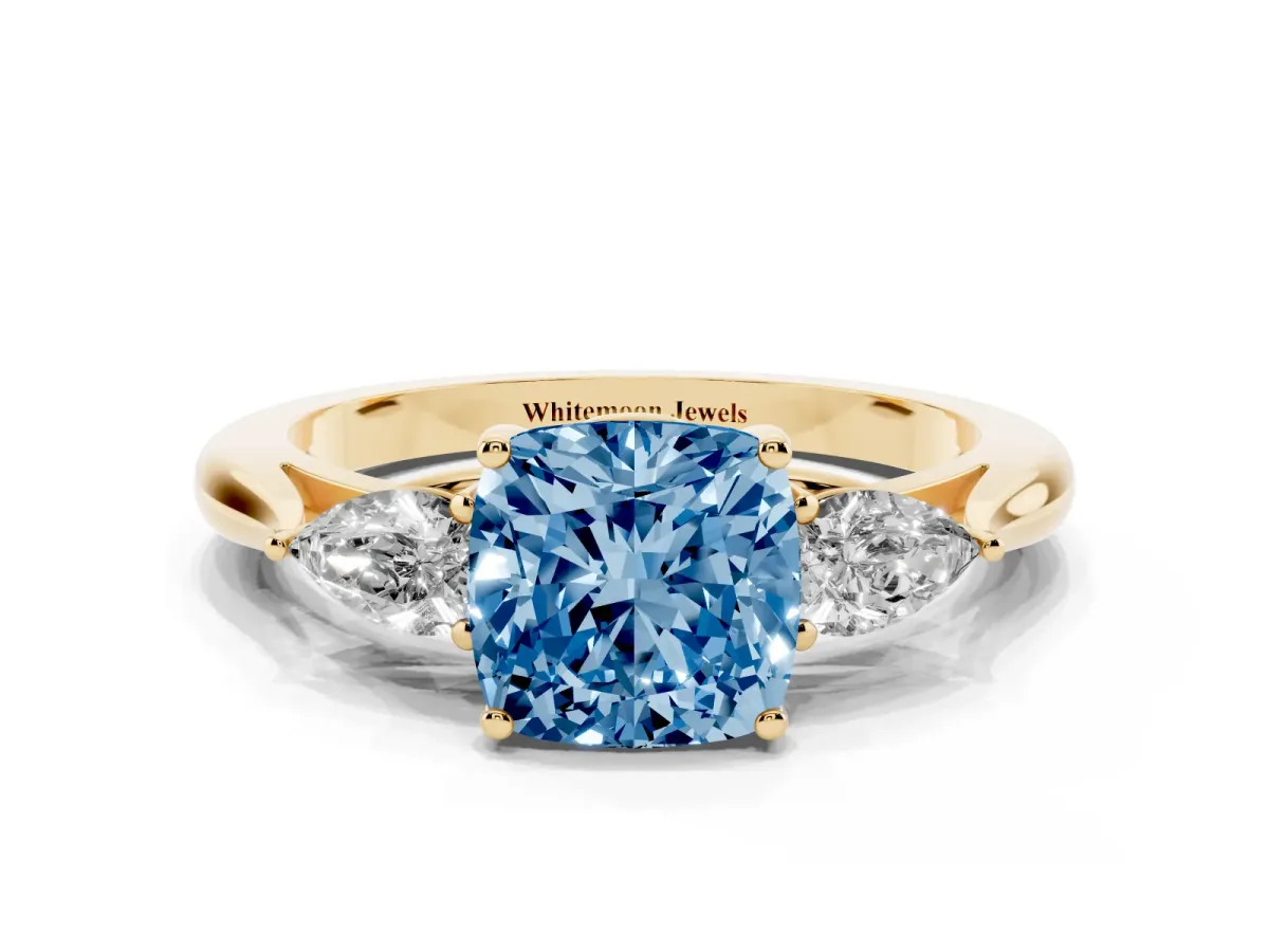 Fancy Blue Three-Stone Cushion Cut Diamond Ring with Pear Side Stones in Four-Prong Setting Yellow gold