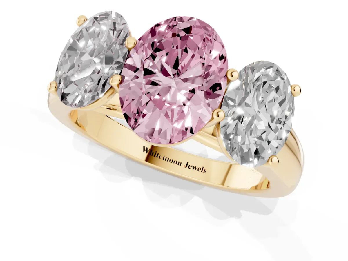 Fancy Pink Oval Cut Three-Stone Diamond Ring with Prong Setting on a Classic Band Yellow gold