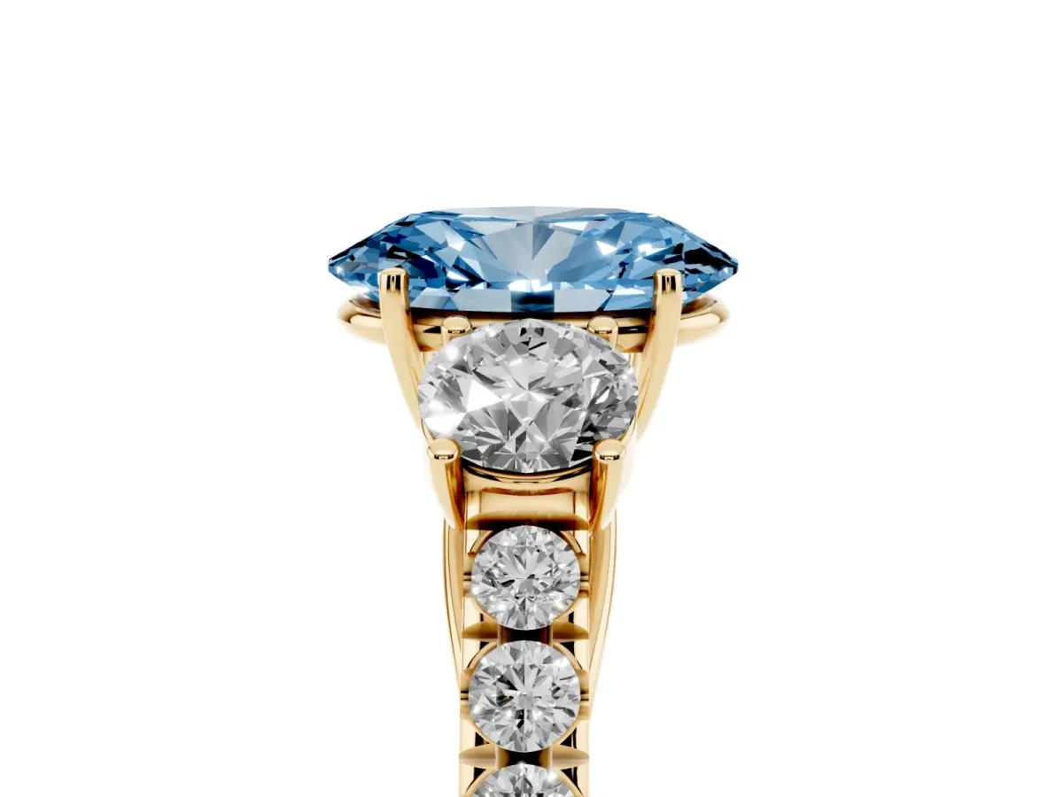 Fancy Blue Oval Cut Cut Diamond Three-Stone Ring with Round Side Stones and Pavé Band Yellow gold