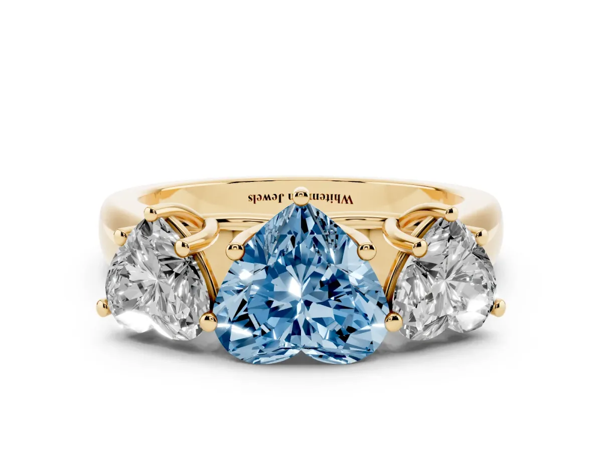 Fancy Blue Heart Cut Three-Stone Diamond Ring with Prong Setting on a Classic Band Yellow gold