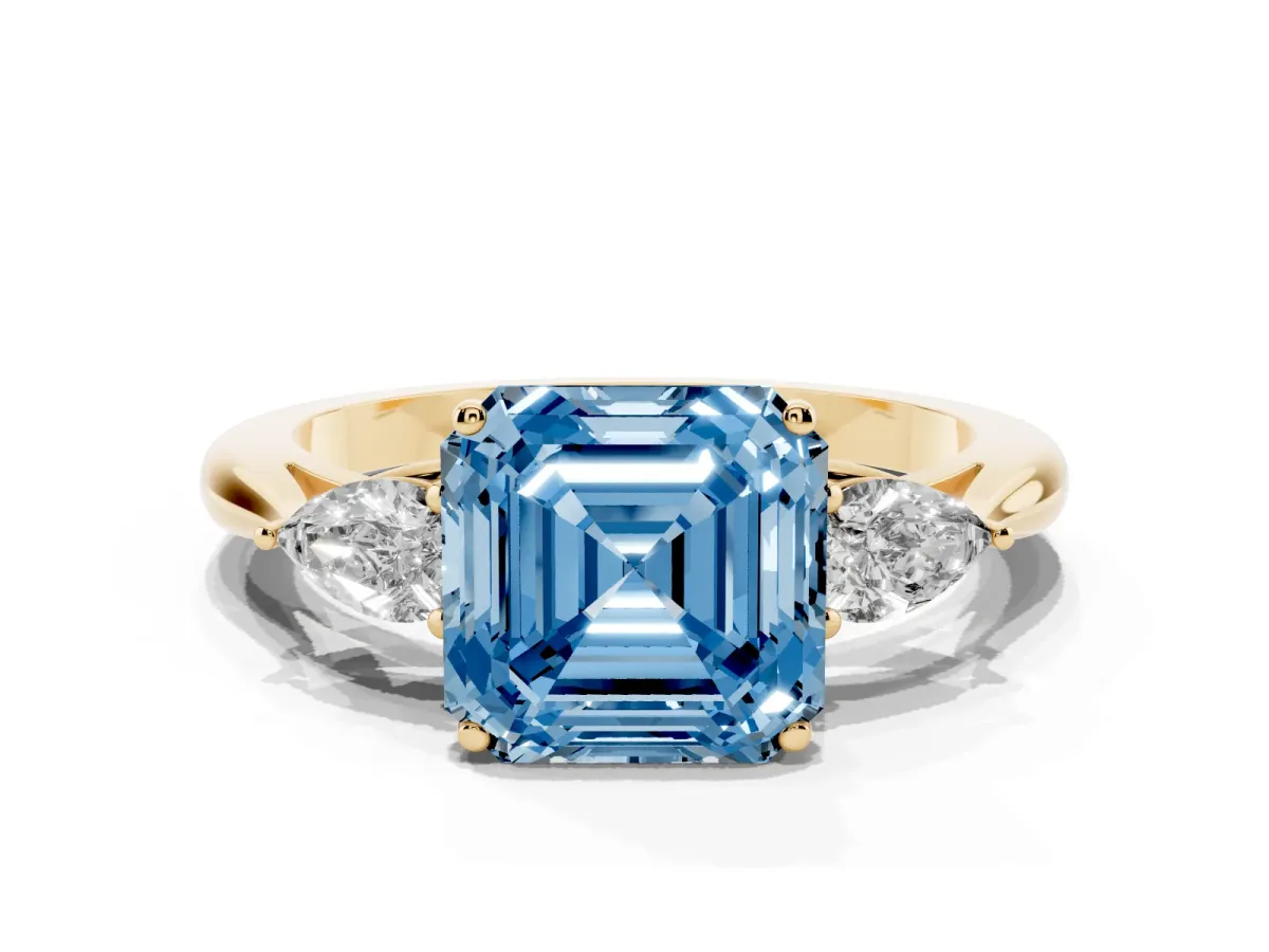 Fancy Blue Three-Stone Asscher Cut Brilliant Diamond Solitaire Ring with Tapered Band and Four-Prong Setting Yellow gold