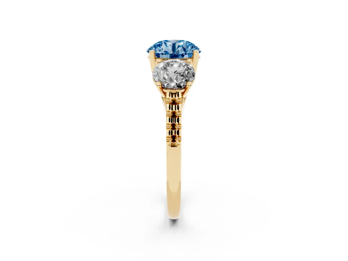 Fancy Blue Three-Stone Round Cut Diamond Ring with Round Pavé Band and Prong Setting Yellow gold