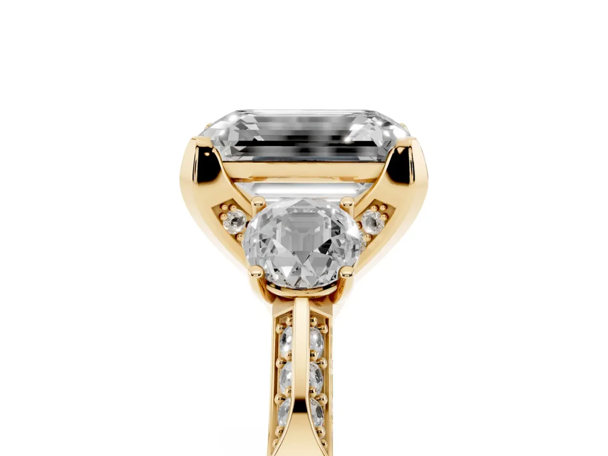 Emerald Cut Brilliant Three-Stone Diamond Ring with Pavé Band and Four-Prong Setting Yellow gold