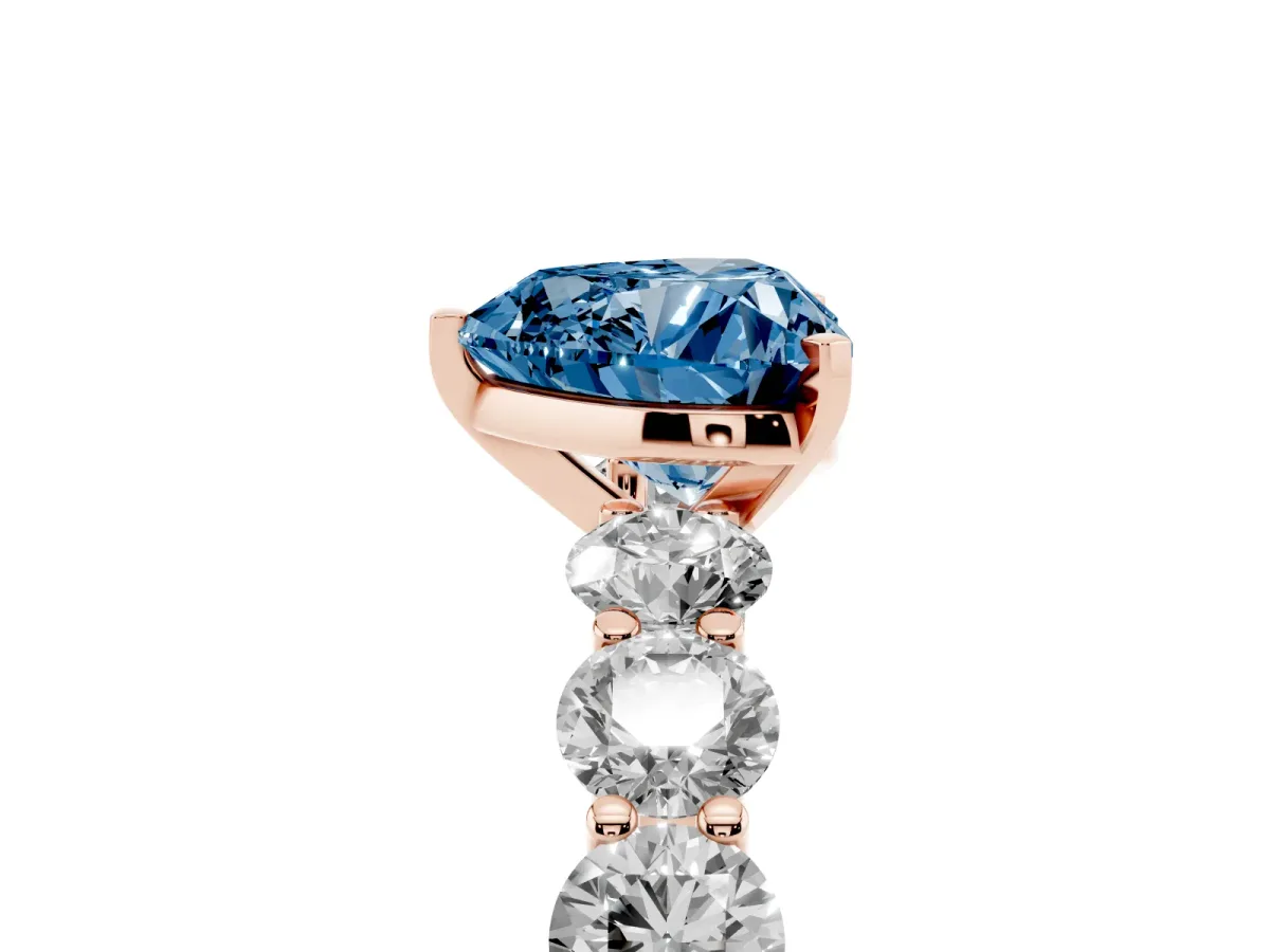 Fancy Blue Heart Cut Diamond Prong Setting with Side Stones on a Pave Band Rose gold