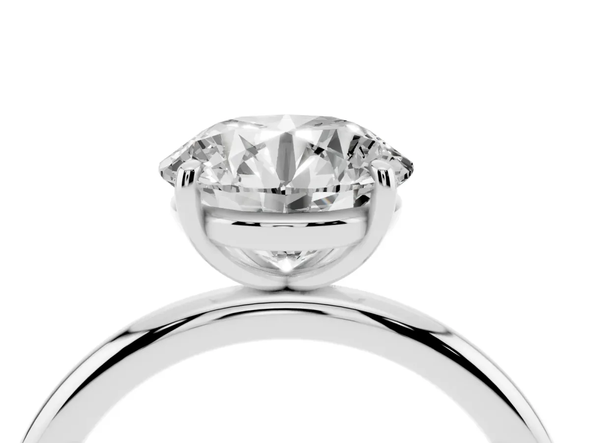 Round Cut Solitaire Diamond Ring with Four-Prong Setting on a Plain Band Platinum