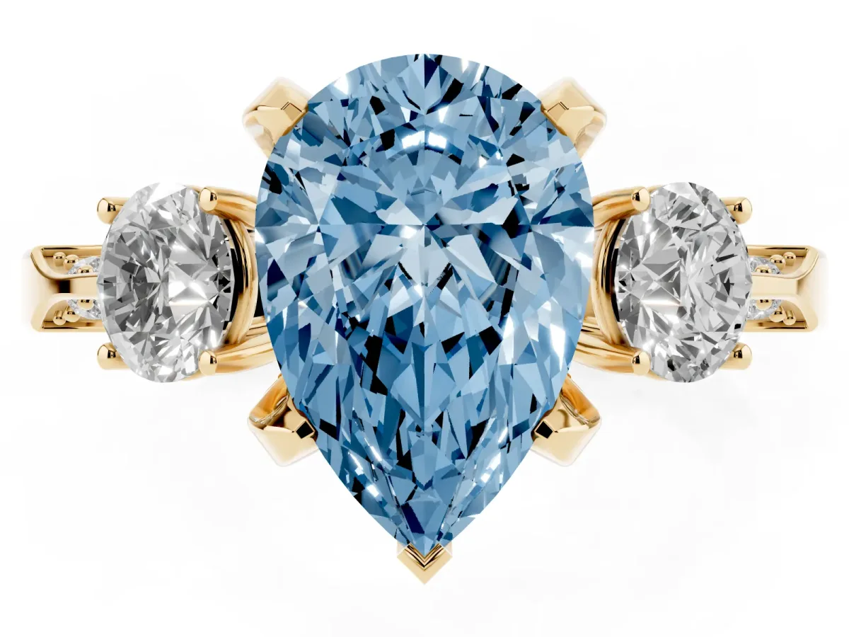 Fancy Blue Pear Cut Brilliant Three-Stone Diamond Ring with Pavé Band and Four-Prong Setting Yellow gold