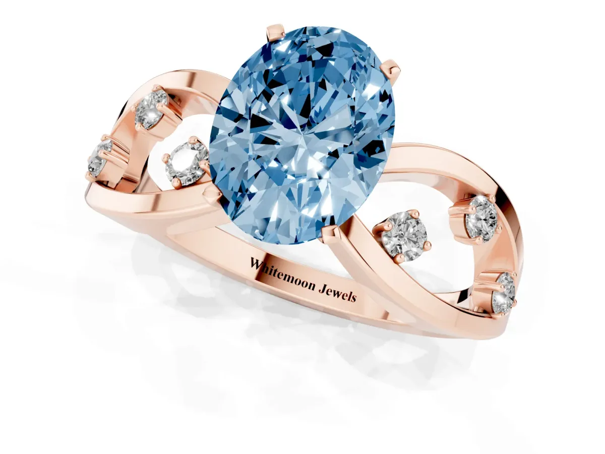 Fancy Blue Oval Cut Cut Solitaire Diamond with Side Stones on Criss-Cross Band and Four-Prong Setting Rose gold