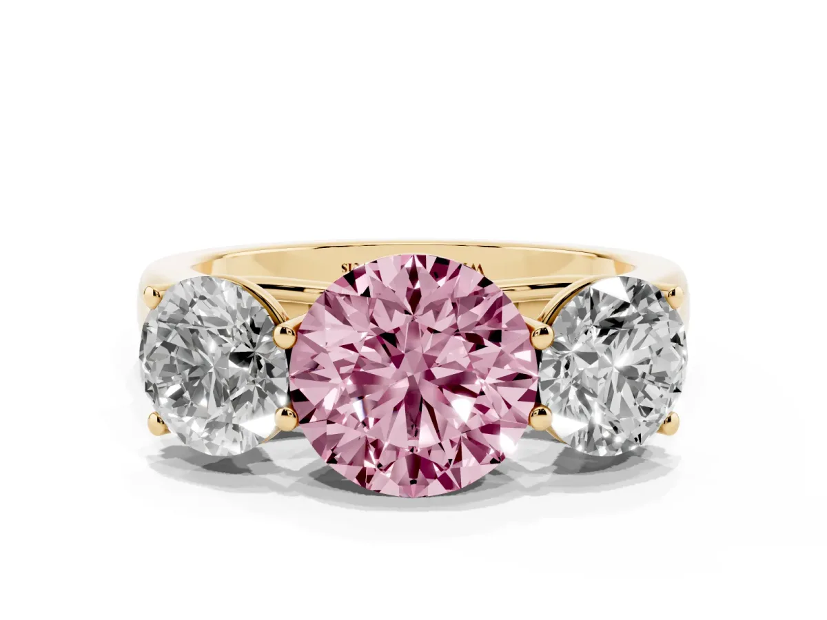 Fancy Pink Round Cut Three-Stone Diamond Ring with Prong Setting on a Classic Band Yellow gold