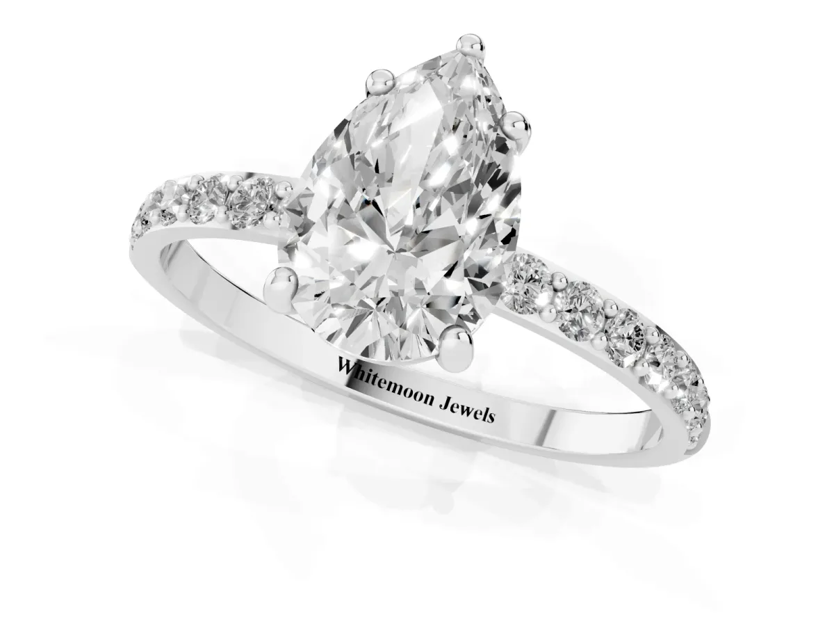 Pear Cut Diamond Solitaire Ring with Round Pavé Band and Prong Setting Silver