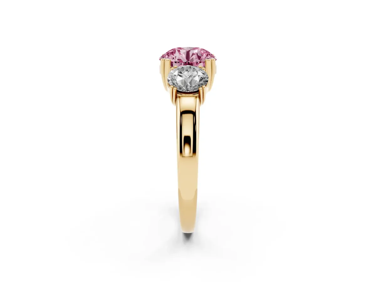 Fancy Pink Three-Stone Round Cut Cut Diamond Ring with Channel Set Band and Four-Prong Setting Yellow gold