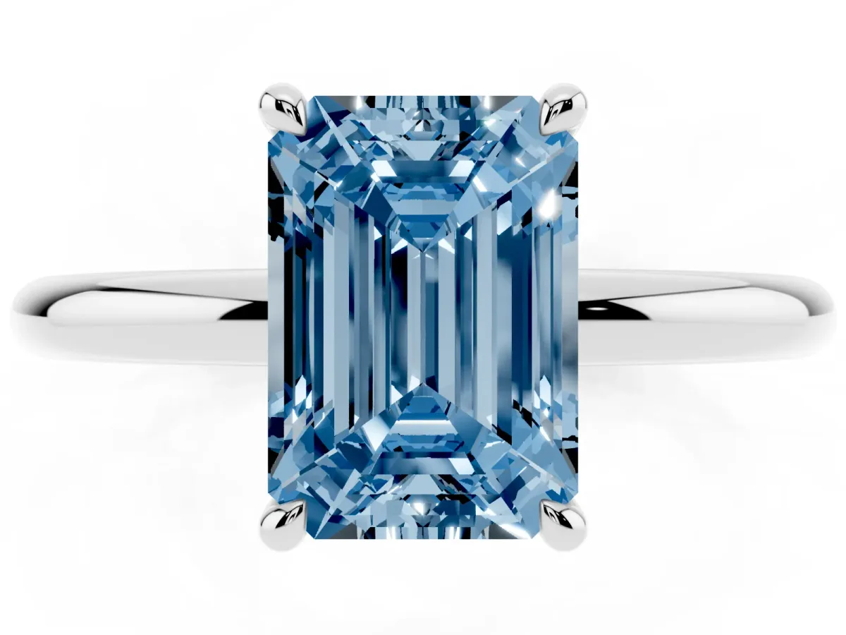 Fancy Blue Emerald Cut Diamond Solitaire Ring with Thin Band and Four-Prong Setting Silver