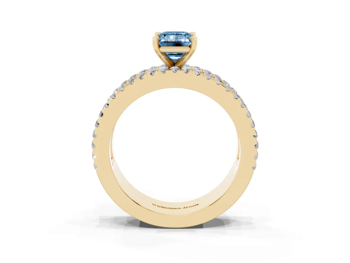 Fancy Blue Emerald Cut Diamond Solitaire Ring with Pavé and Channel Set Band Yellow gold