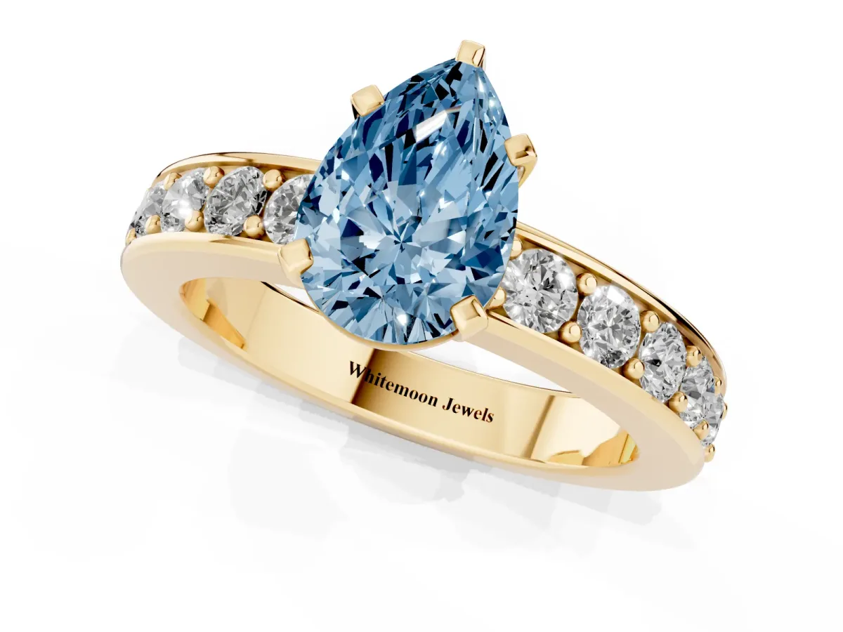 Fancy Blue Pear Cut Diamond Engagement Ring with Channel Set Round Band and Prong Setting Yellow gold