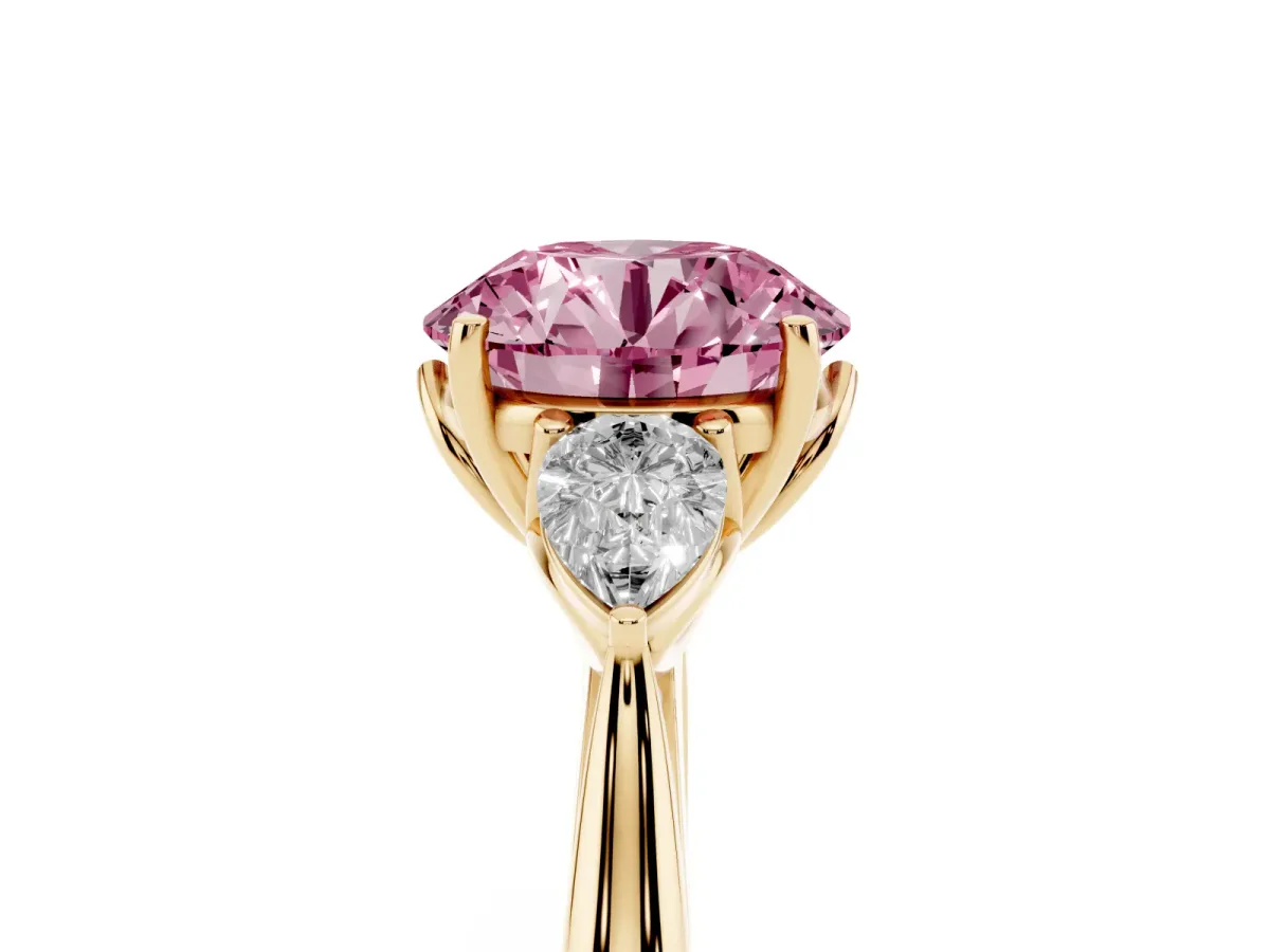 Fancy Pink Three-Stone Round Cut Diamond Ring with Pear Side Stones in Four-Prong Setting Yellow gold