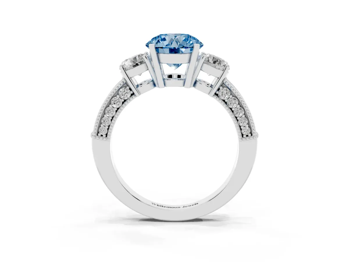 Fancy Blue Round Cut Three-Stone Diamond Ring with Pavé Band and Four-Prong Setting Silver