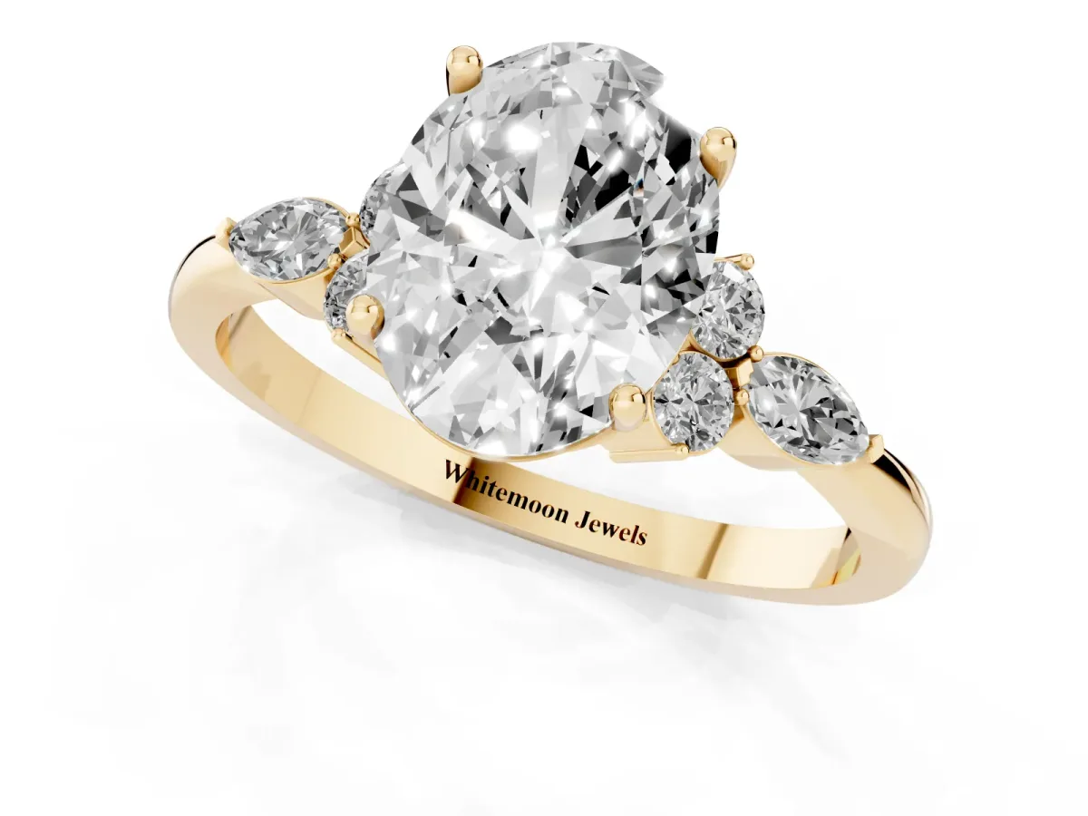 Oval Cut Brilliant Diamond Solitaire Ring with Pear Side Stones and Four-Prong Setting Yellow gold