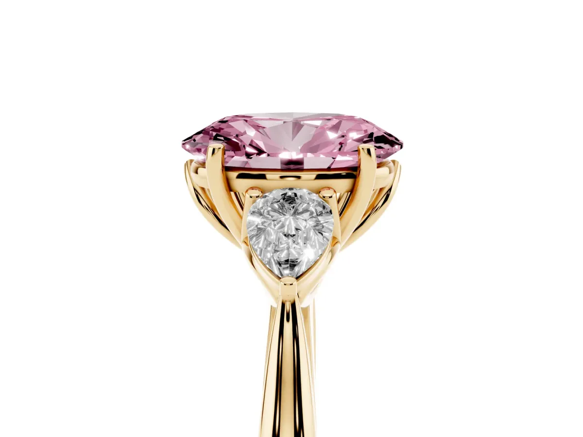 Fancy Pink Three-Stone Oval Cut Diamond Ring with Pear Side Stones in Four-Prong Setting Yellow gold