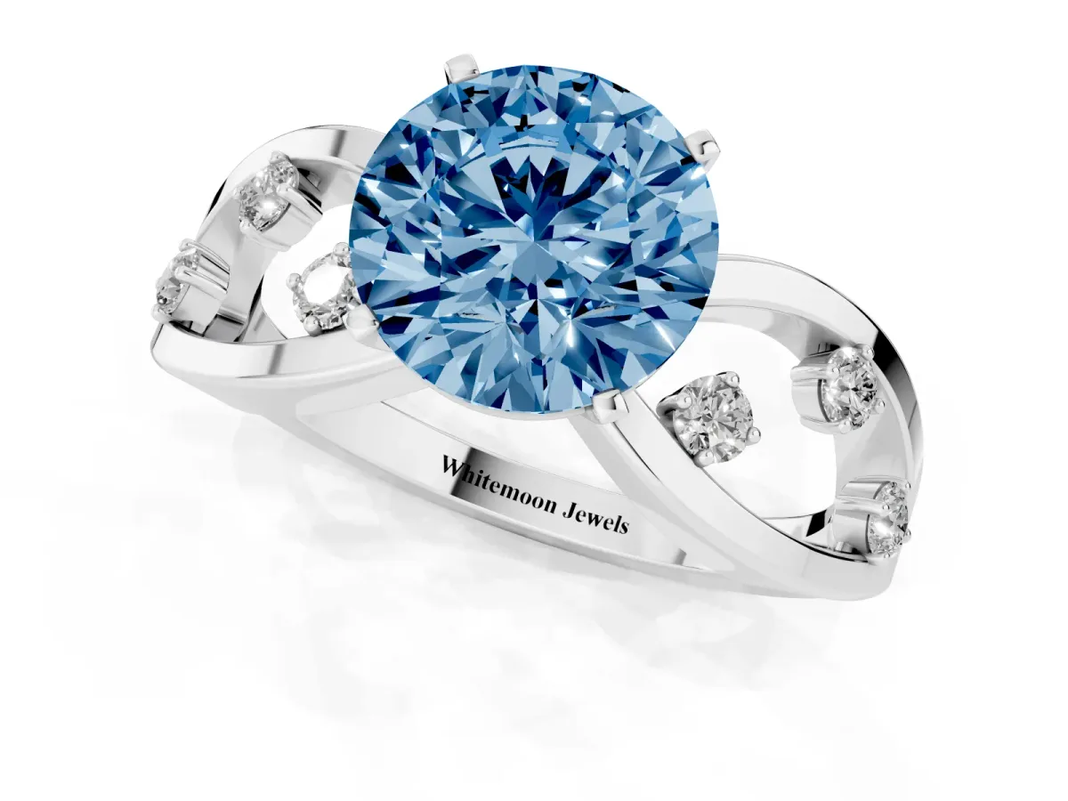 Fancy Blue Round Cut Cut Solitaire Diamond with Side Stones on Criss-Cross Band and Four-Prong Setting Silver
