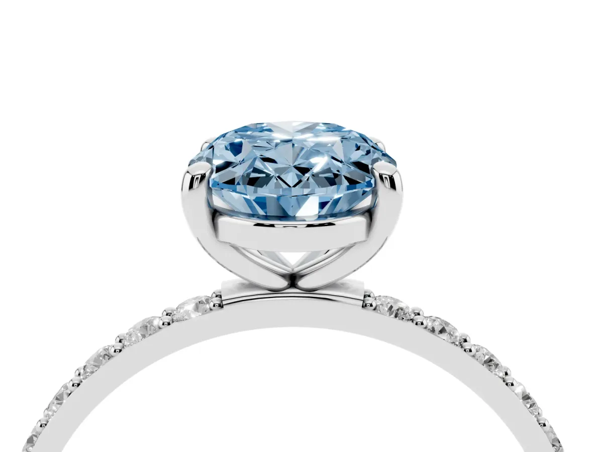 Fancy Blue Oval Cut Diamond Solitaire Ring with Round Pavé Band and Prong Setting Silver