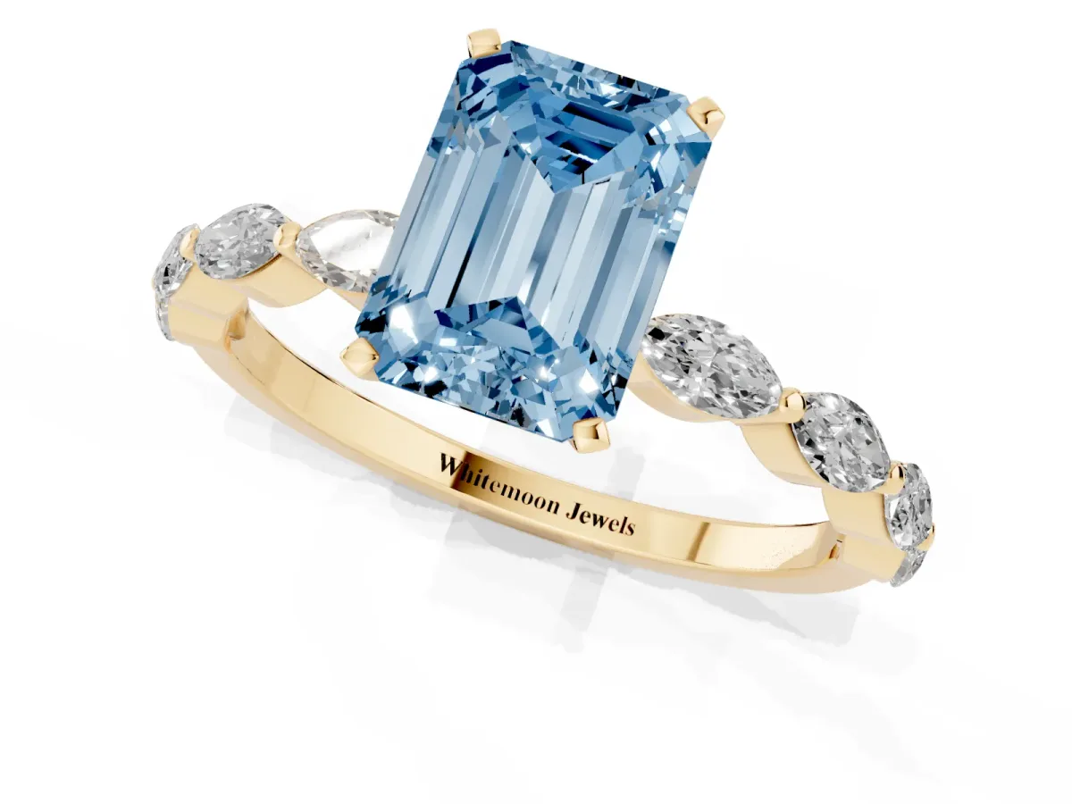 Fancy Blue Emerald Cut Diamond Ring with Marquise Side Stones and Prong Setting Yellow gold