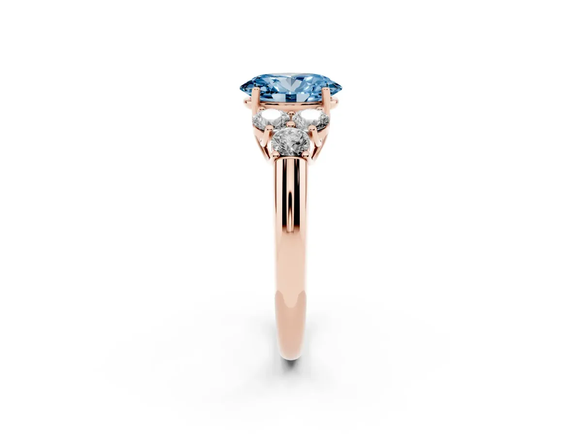 Fancy Blue Oval Cut Cut Diamond Cluster Ring with Round Accent Stones and Prong Setting on a Classic Band Rose gold