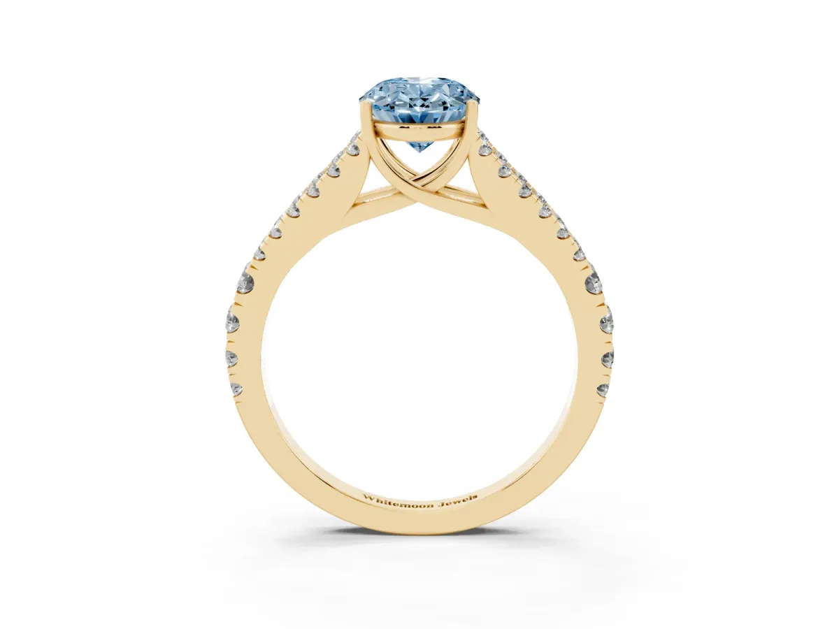 Fancy Blue Oval Cut Diamond Split Shank Pavé Engagement Ring with Four-Prong Setting Yellow gold