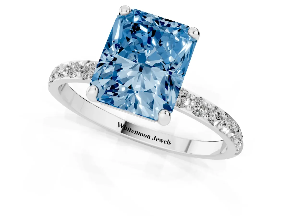 Fancy Blue Radiant Cut Diamond Solitaire Ring with Round Pavé Band and Prong Setting Silver