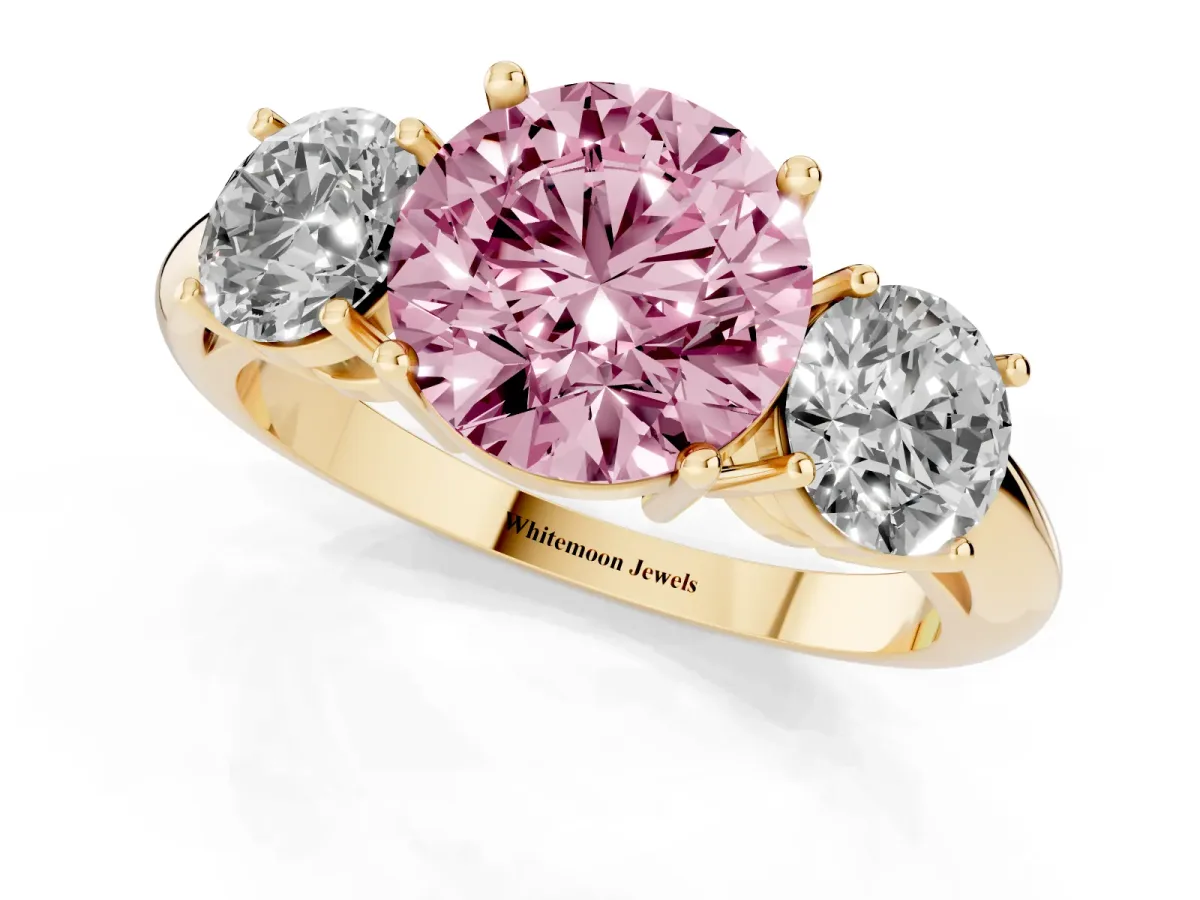 Fancy Pink Three-Stone Round Cut Cut Diamond Engagement Ring with Prong Setting on a White Gold Band Yellow gold
