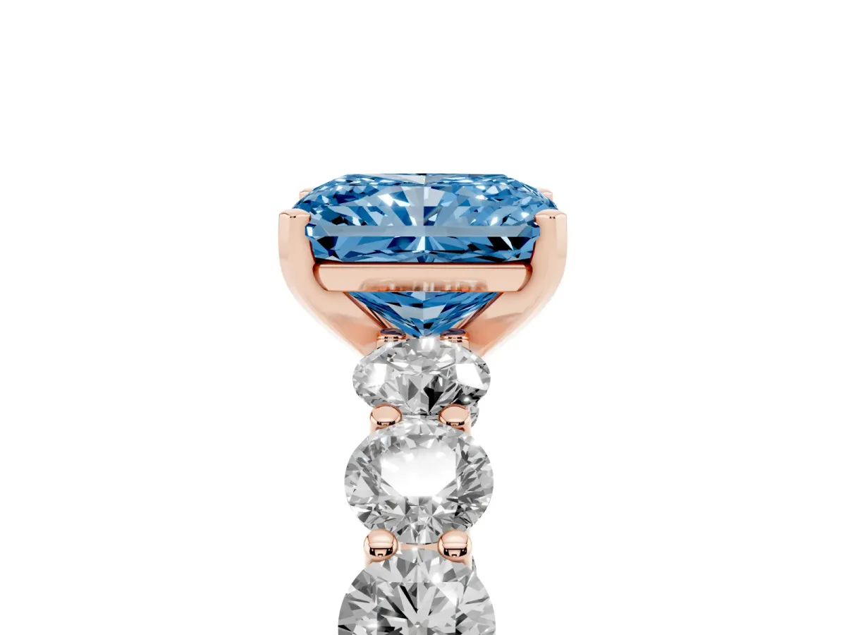 Fancy Blue Radiant Cut Diamond Prong Setting with Side Stones on a Pave Band Rose gold