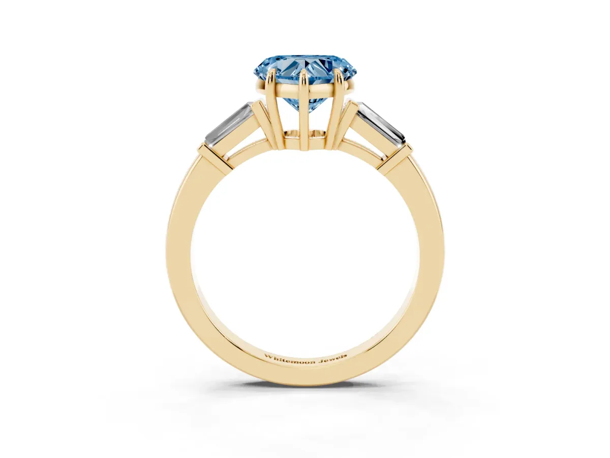 Fancy Blue Heart Cut Diamond Three-Stone Ring with Tapered Baguette Side Stones and Prong Setting Yellow gold