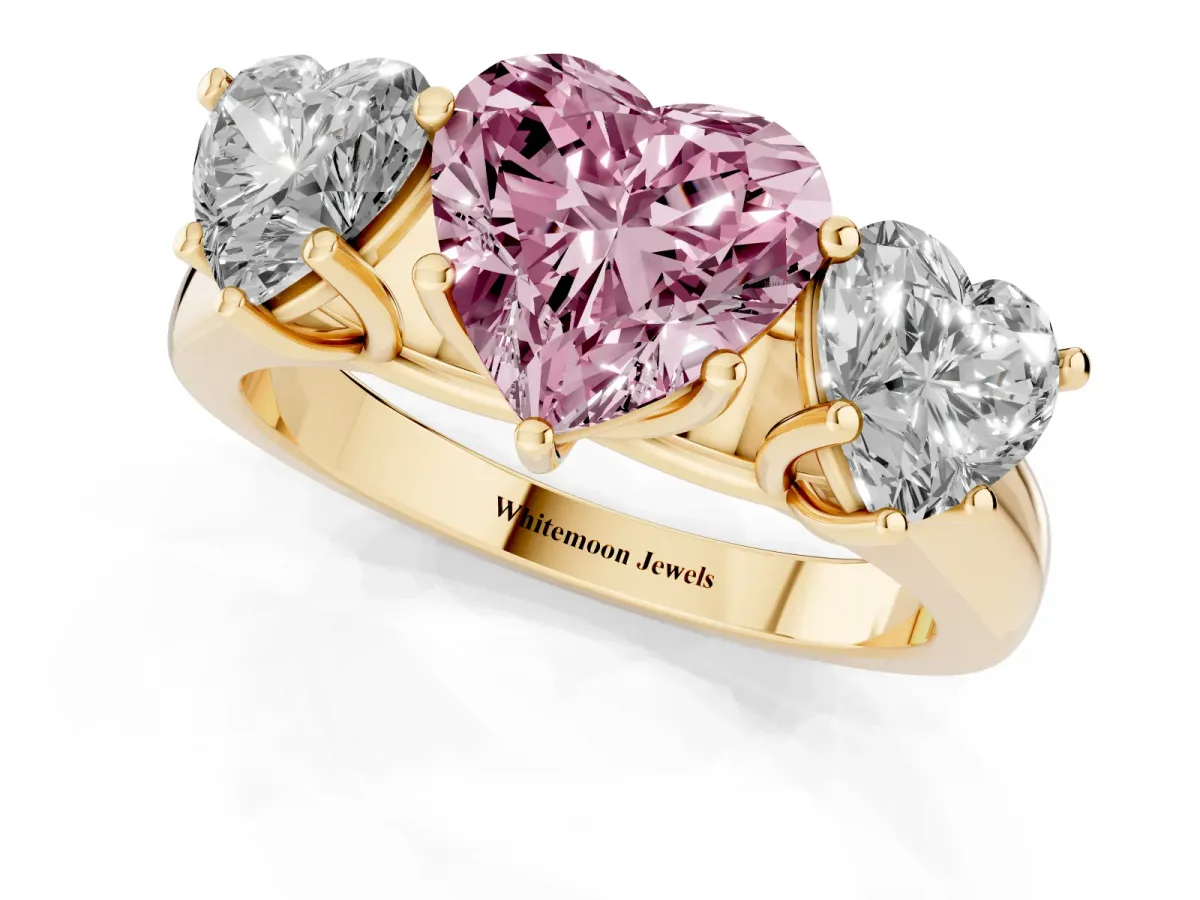 Fancy Pink Heart Cut Three-Stone Diamond Ring with Prong Setting on a Classic Band Yellow gold