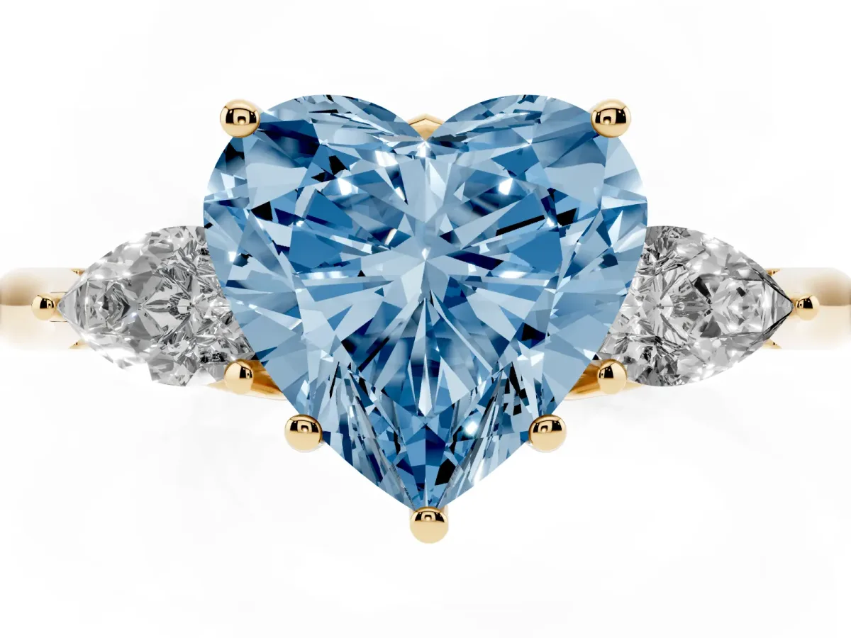 Fancy Blue Three-Stone Heart Cut Diamond Ring with Pear Side Stones in Four-Prong Setting Yellow gold