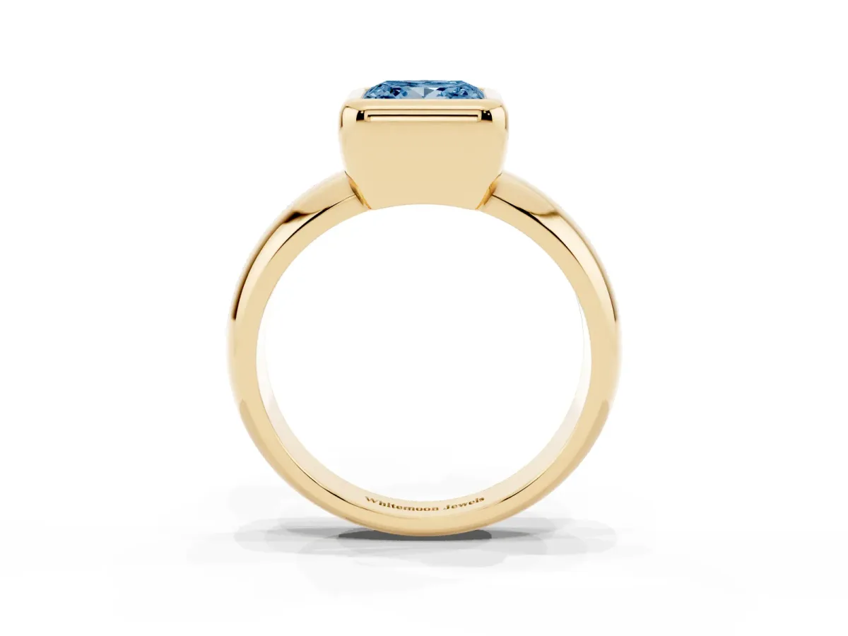 Fancy Blue Bezel Set Princess Cut Solitaire Ring with Wide Band Yellow gold