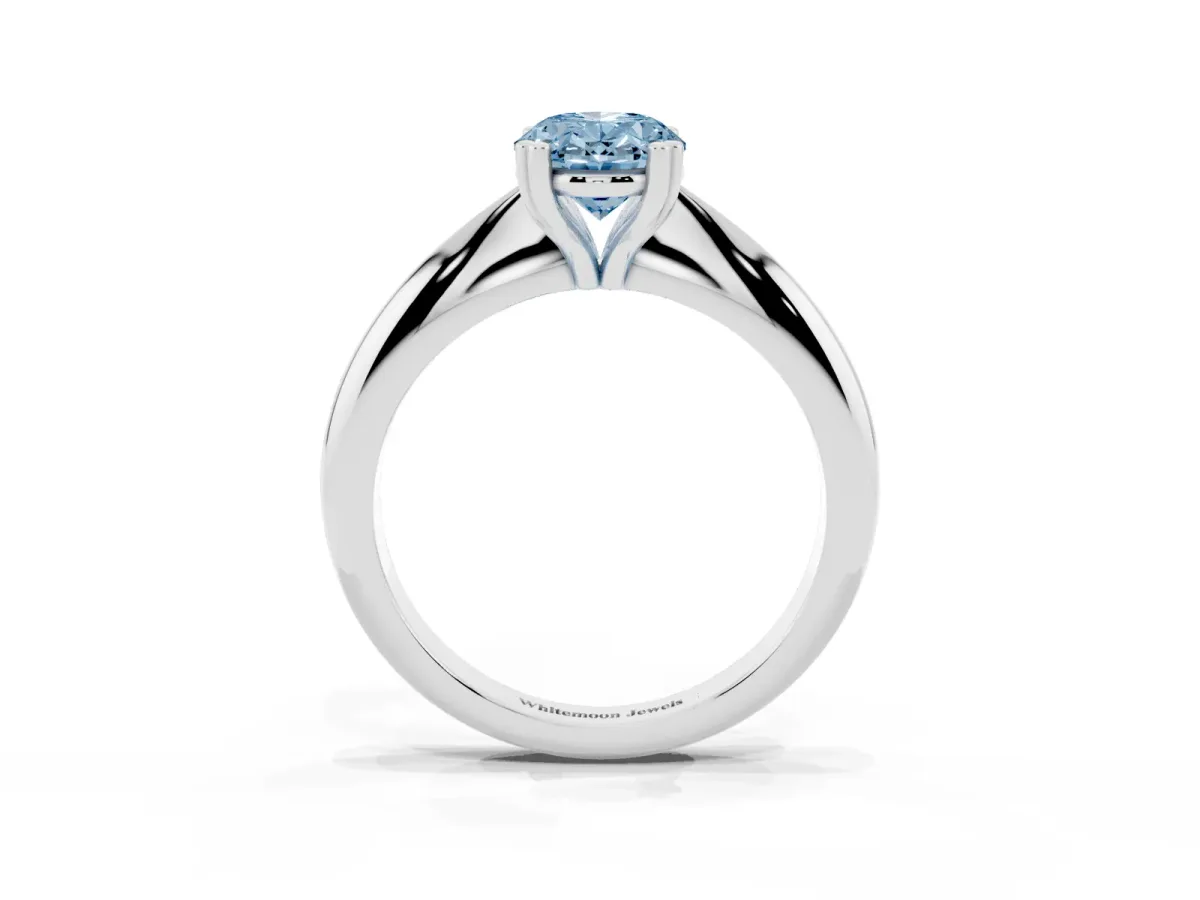 Fancy Blue Oval Cut Cut Solitaire Engagement Ring with Tapered Band and Four-Prong Setting Silver