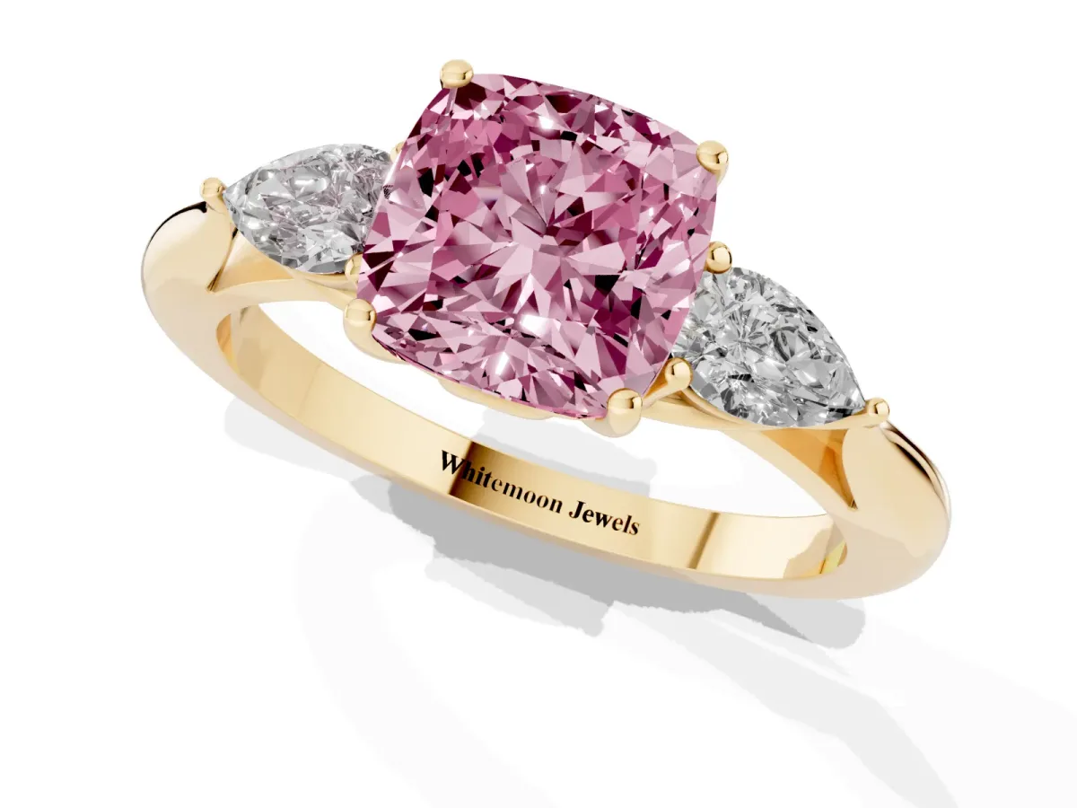 Fancy Pink Three-Stone Cushion Cut Diamond Ring with Pear Side Stones in Four-Prong Setting Yellow gold