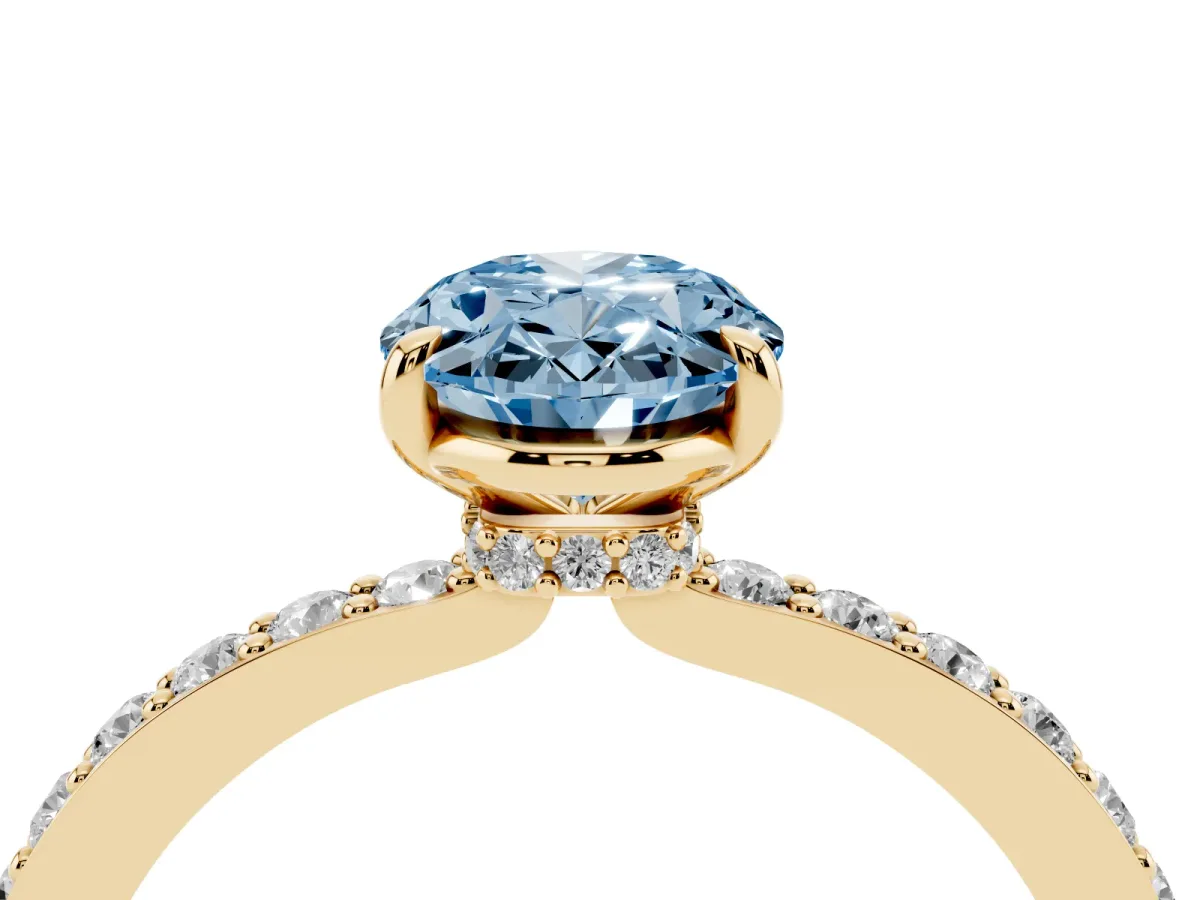 Fancy Blue Oval Cut Diamond Pavé Engagement Ring with Round Accents and Prong Setting Yellow gold
