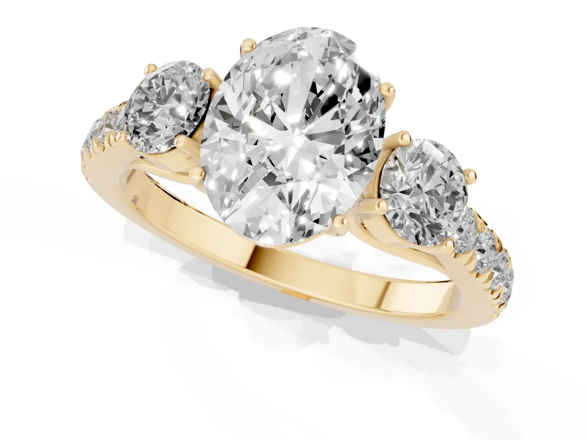 Oval Cut Cut Diamond Three-Stone Ring with Round Side Stones and Pavé Band Yellow gold