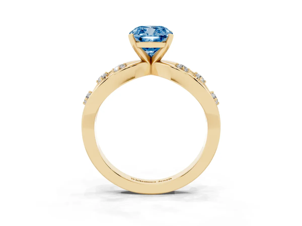 Fancy Blue Cushion Cut Cut Solitaire Diamond with Side Stones on Criss-Cross Band and Four-Prong Setting Yellow gold