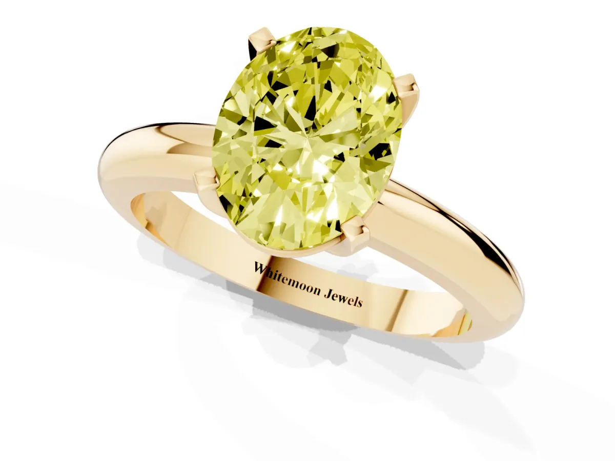 Fancy Yellow Oval Cut Diamond Solitaire Engagement Ring with Round Band and Four-Prong Setting Yellow gold