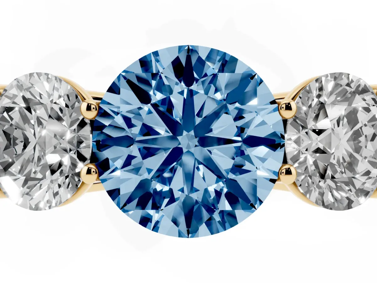 Fancy Blue Round Cut Three-Stone Diamond Ring with Prong Setting on a Classic Band Yellow gold
