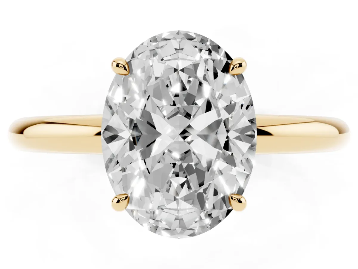Oval Cut Diamond Solitaire Ring with Thin Band and Four-Prong Setting Yellow gold