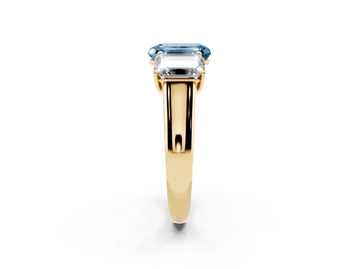 Fancy Blue Emerald Cut Three-Stone Diamond Ring with Prong Setting on a Classic Band Yellow gold