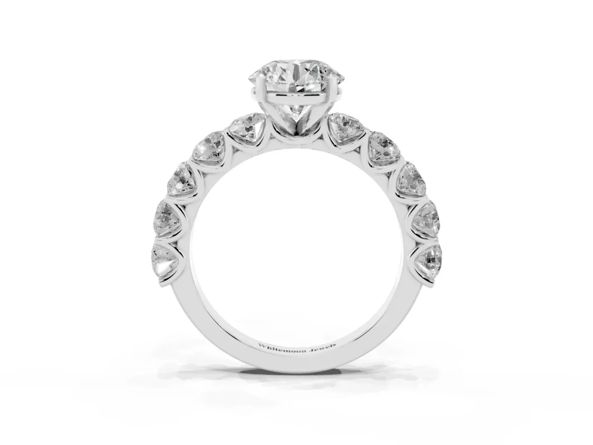 Round Cut Diamond Prong Setting with Side Stones on a Pave Band Silver
